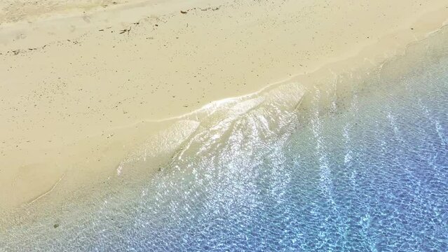 Top view beach sand background for summer vacation concept. Beach nature and summer seawater with sunlight light sandy beach Sparkling sea water	