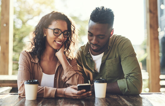 Scroll, man and woman in cafe with phone, smile and connection for online dating relationship. Flirt, love and happy couple in coffee shop together with mobile app for contact, romance and networking