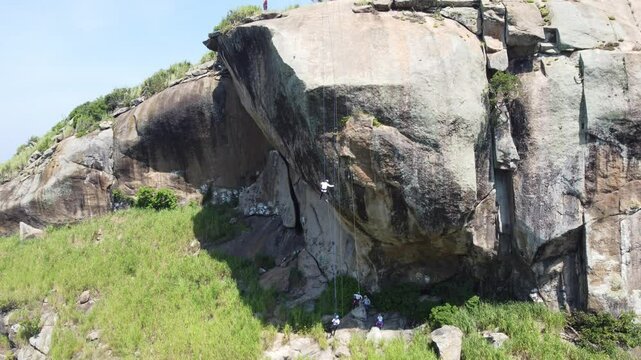 People rappelling in a wild area of ​​Rio de Janeiro, Brazil, South America. Pedra da Tartaturga - Praia do Perigoso.