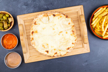 Manakeesh, Turkish arabic pizza, flat bread topped with Akkawi cheese, Labna and zaater for breakfast. Homemade mediterranean flat bread manakish. Arabic cuisine.