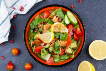 Arabic or Turkish Rocca Fresh Salad. Fresh green leaves, lettuce, arugula, rocket salad with mozzarella, pomegranate seeds, avocado, onions and coriander leaves.