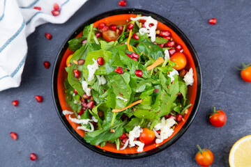 Arabic or Turkish Rocca Fresh Salad. Fresh green leaves, lettuce, arugula, rocket salad with mozzarella, pomegranate seeds, avocado, onions and coriander leaves.