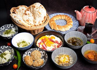 Middle eastern, Turkish or arabic Breakfast and assorted meze, concrete rustic background. Meat kebab, falafel, baba ghanoush, muhammara, hummus, sambusak, rice, tahina, kibbeh, pita. Lebanese cuisine