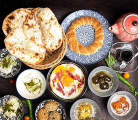 Middle eastern, Turkish or arabic Breakfast and assorted meze, concrete rustic background. Meat kebab, falafel, baba ghanoush, muhammara, hummus, sambusak, rice, tahina, kibbeh, pita. Lebanese cuisine