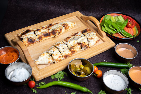 Turkish or Arabic traditional pita with sujuk and cheese. Turkish Beef and Chicken Kawarma with ries sauce and Olives.