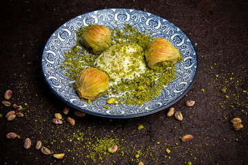 Delicious Turkish baklava served with pistachio cream and cream ice cream on a plate. Turkish Ramadan Dessert Baklava kadayif with ice cream concept background