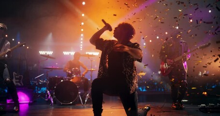 Young Indie Band Playing a Rock Music Gig with Alternative Punk Tracks at a Festival with Energetic Music Fans. Five Charismatic Musicians Make a Live Performance Under Falling Confetti