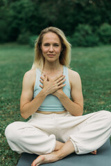 young woman athlete in sportswear practices yoga, enjoys training