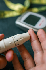 Man measuring blood sugar, close-up