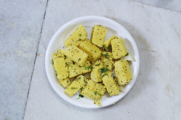traditional indian gujarati snack khaman dhokla fast food dish made from chana dal,closeup,top view...