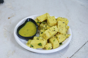 traditional indian gujarati snack khaman dhokla fast food dish made from chana dal,closeup,top view with selective focus
