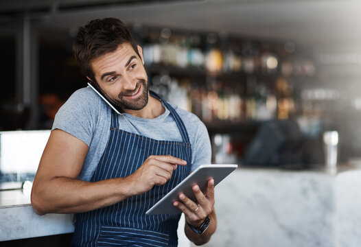 Man, waiter and phone call, online and tablet for booking with order or conversation at cafe. Male person or barista talking with smile, technology or mobile smartphone on reservation at restaurant