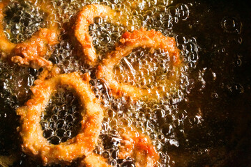 calamari rings being cooked in hot oil