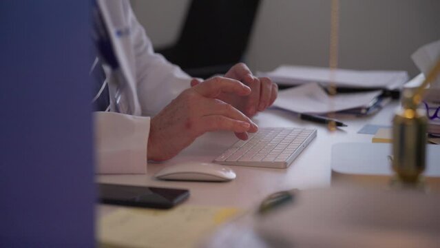 Close-up of doctor's hands typing on a keyboard recording patients' medical data. Concept of Administration, Medical documentation, Healthcare, Office work 