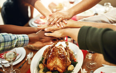 Christmas, food and hands of people in home for dinner party, celebration and festive event. Friends, diversity and group at feast, lunch or gourmet meal for holiday, eating together and Thanksgiving