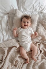 A young baby lies on a bed surrounded by pillows, capturing a tender moment