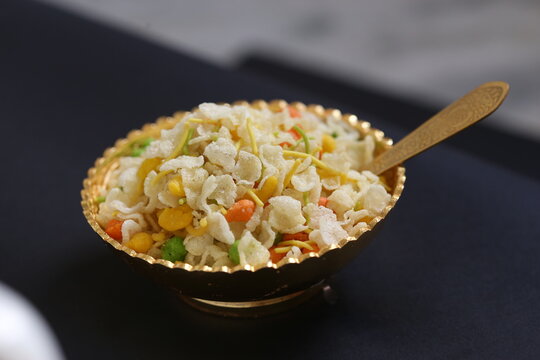 Jada Poha Namkeen Chivda / Thick Pohe Chiwda is a jar snack with a mix of sweet, salty and nuts flavours, served with tea. selective focus