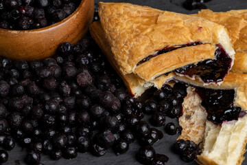 a bun and freshly frozen blueberries harvested in the forest