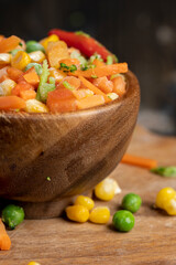 a mixture of quick-frozen corn, peas, peppers, and carrots
