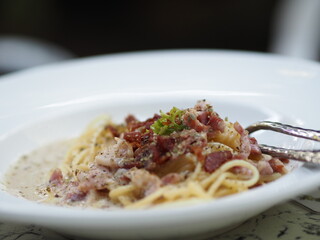 Spaghetti Carbonara with Unsmoked Bacon, Pancetta, Guanciale Heavy Cream, spaghetti alla carbonara food in white plate on the table