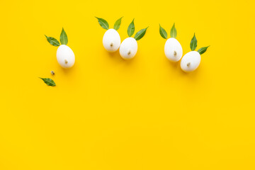 Easter layout with bunnies made of eggs and leaves. Top view