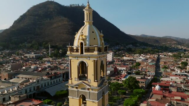 Bell Tower Of Our Lady Of The Sagrario Sanctuary In Tamazula, Jalisco, Mexico. drone pullback, tilt-down