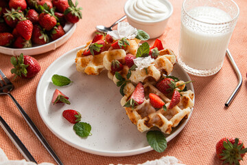 Belgian waffles with fresh strawberries in a plate. Viennese waffles