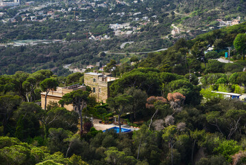 View from Tibidabo church on the house with swimming pool in green vegetation