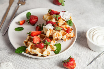 Belgian waffles with fresh strawberries in a plate. Viennese waffles