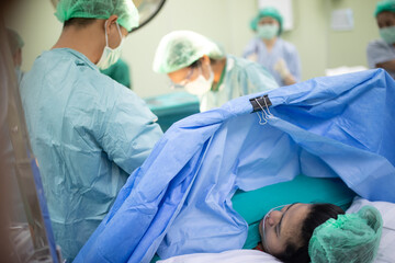 Young Asian mother feel painful during Cesarean sections in delivery room