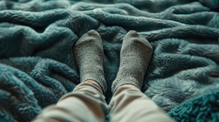 A person reclining on a bed with their feet up, great for depicting relaxation and leisure time