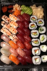 Assorted sushi platter featuring fresh salmon, tuna, and avocado for a delectable dining experience