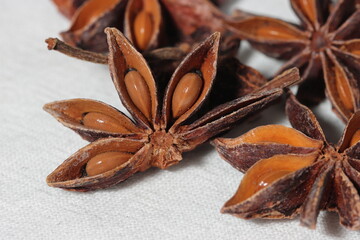 Star anise. Some star anise fruits with seed. Macro close-up on the jute burlap surface in rustic style.