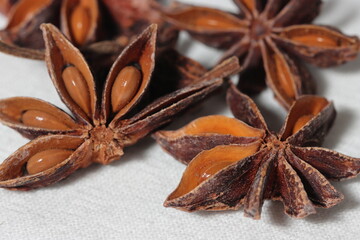 Star anise. Some star anise fruits with seed. Macro close-up on the jute burlap surface in rustic style.