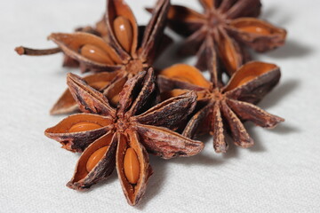 Star anise. Some star anise fruits with seed. Macro close-up on the jute burlap surface in rustic...