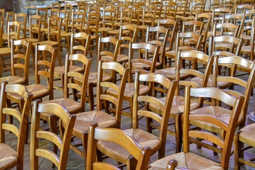 Fototapeta premium old vintage wooden seats inside a church in France