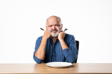 Concept showing Indian asian retired senior old man with empty ceramic plate, holding, presenting...