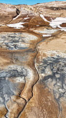 Impressive geothermal area Hverir Island with its smoke columns, red Mars-like soil and moon-like craters, mountains and hot black areas