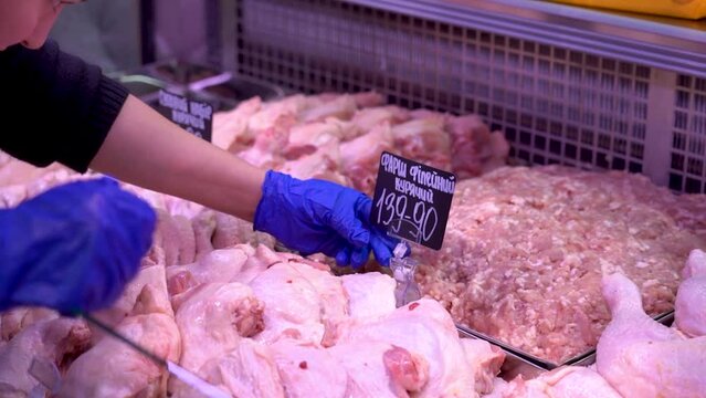 Sumy, Ukraine - December 21, 2023: Meat products store. Sausages on display at a grocery store. Sausage price tags.