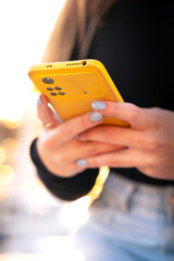 Vertical portrait young boy using smartphone app outdoors.