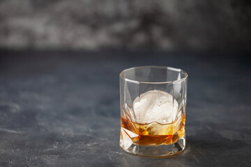 Glass of delicious Old Fashioned Cocktail on dark background