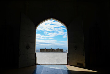 Open church door with a blue sky. Reflector for lighting up the church