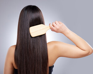 Woman, back and hair care in studio for brush, hairdresser and beauty salon on white background. Girl, comb and hairstyle with healthy texture, wellness or treatment with growth transformation