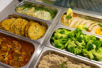 Metal trays with fresh food in a buffet