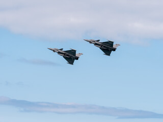 Normandy, France - June 8, 2024: Two French Naval Air Force F-16 fighters in flight during D-Day to mark the 80th anniversary of the landing of Allied forces in Normandy, France, Aromanches