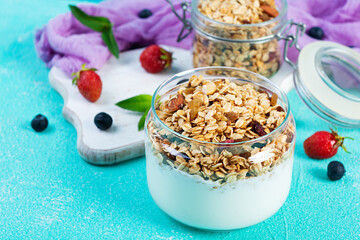 Granola with yogurt and fresh berries. Healthy breakfast of oat muesli