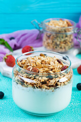 Granola with yogurt and fresh berries. Healthy breakfast of oat muesli
