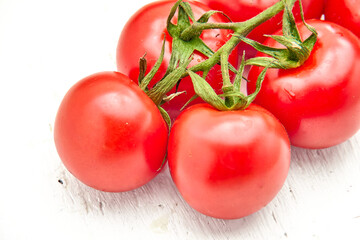 Ripe cherry tomatoes on a white structural background.