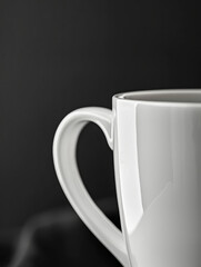 White ceramic coffee mug with handle, close-up, black background.