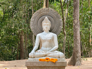 The white buddha statue in the Suan mokkh garden at Suan Mokkhaphalaram temple.